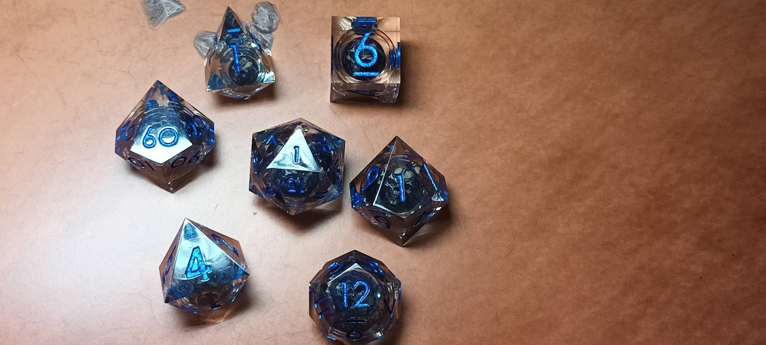 7 x Polyhedral Dice Resin Liquid Core Skull Grey with Blue Dice